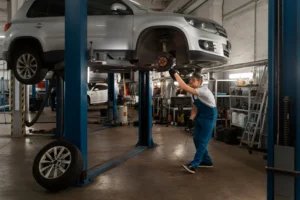male-mechanic-working-shop-car-scaled.jpg